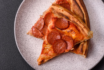 Pepperoni pizza with sausage, mozzarella cheese, tomatoes, salt and spices
