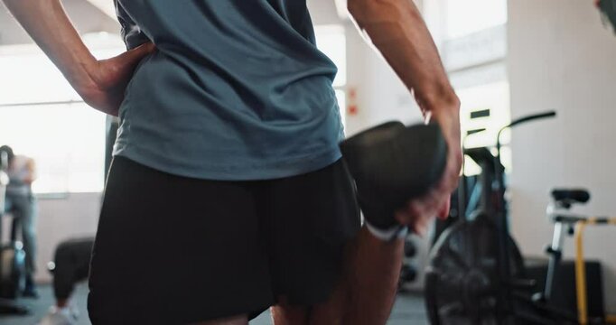 Warm up, stretching and legs of man in gym for performance, wellness and fitness. Sports health, preparation and person back for exercise, bodybuilder training and workout ready for flexibility