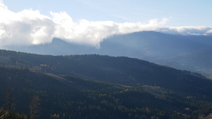 Scenic autumn landscape with clouds rolling over a mountain range of Jeseniky mountains, Czech...