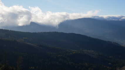 Scenic autumn landscape with clouds rolling over a mountain range of Jeseniky mountains, Czech...