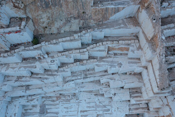 Aerial view of Open-air mining activity in a white marble mine.