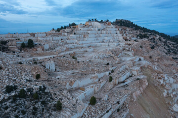 Aerial view of Open-air mining activity in a white marble mine.