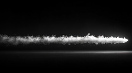 A horizontal stream of white smoke against a black background.