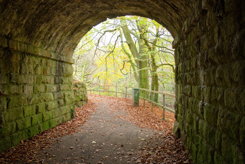 Old stone railway bridge arch and foot path