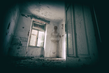 Horror scene of scary female ghost in white dress, vintage look