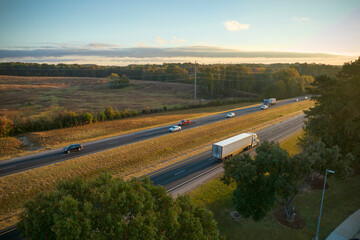 View from above of busy american highway with fast moving trucks and cars. Interstate...