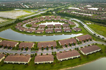View from above of densely built residential houses near retention ponds in closed living clubs in...