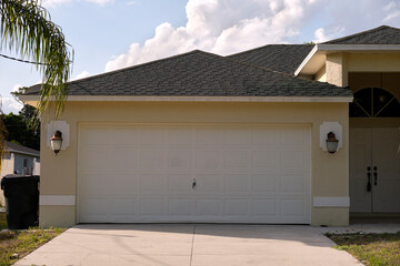 Wide garage double door and concrete driveway of new modern american house