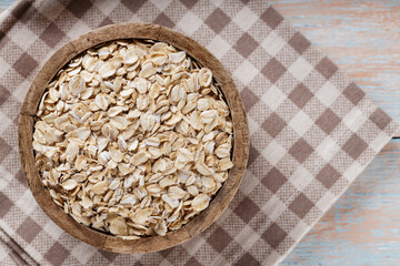Oatmeal in Wooden Bowl on Old Boards, Copy Space
