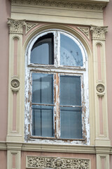 Window with a wooden frame and a white curtain