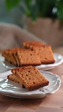 Traditional Swiss spiced bread, Biberfladen, sliced and served on plates. This aromatic bread, filled with honey and nuts, offers a cozy, festive feel, perfect for winter holiday promotions, social