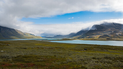 Breathtaking scenic view to the wide mountain valley with lakes and mountains on horizon, splendid scandinavia landscape seen while hiking Kungsleden trail in nordic nature of swedish Lapland. Sweden