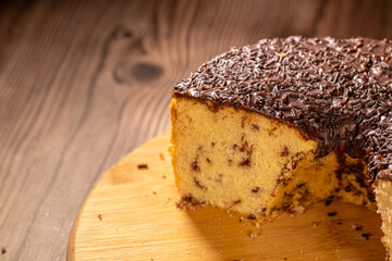 Brazilian Chocolate Chip Cake with Chocolate Frosting on Wooden Board