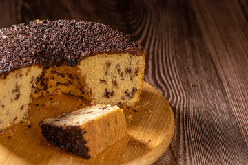 Brazilian Chocolate Chip Cake with Chocolate Frosting on Wooden Board