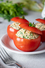 Stuffed tomatoes with cheese, dill and garlic on white plate