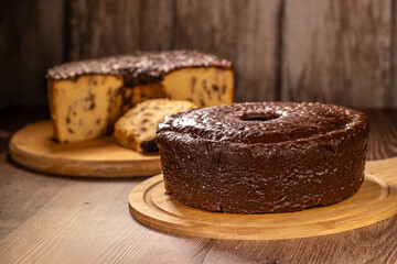 Brazilian Chocolate Covered Cake with Chocolate Chip Cake in Background on Wooden Boards