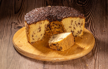 Brazilian Chocolate Chip Cake with Chocolate Frosting on Wooden Board