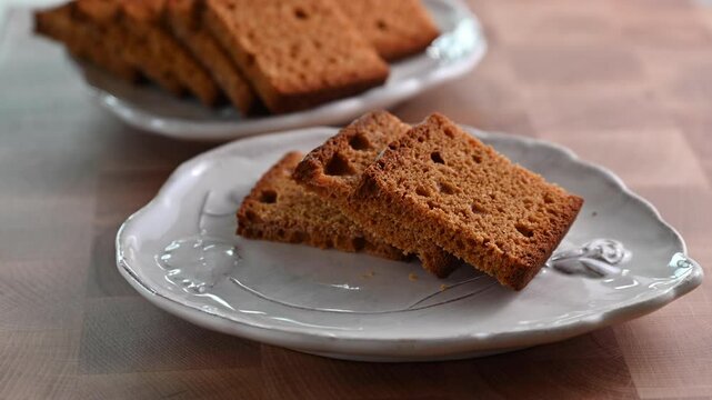 Traditional Swiss spiced bread, Biberfladen, sliced and served on plates. This aromatic bread, filled with honey and nuts, offers a cozy, festive feel, perfect for winter holiday promotions, social