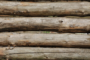 Background, texture of forest felled logs of wood, house walls. Close-up photo, concept of construction in nature.