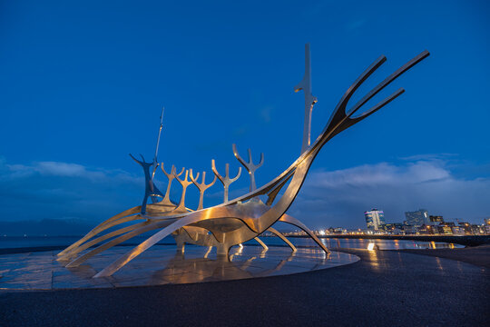Reykjavik, Iceland - October 25, 2024: The modern Sun Voyager sculpture at blue hours at the Reykjavik coast