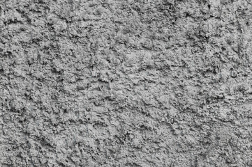 Background, texture of gray uneven rough wall made of stone, cement. Photography, abstraction.