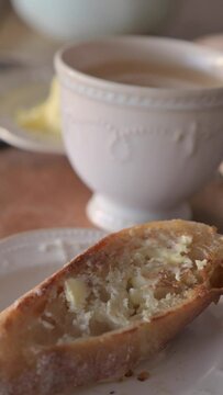 French baguette with butter for breakfast. Fresh crusty bread with farm butter. in life style. atmospheric French breakfast. High quality FullHD footage