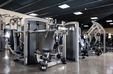 Interior of modern gym with weight training machines for beginners and professional athletes....