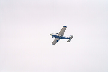 A plane with a propeller flies high in the sky.