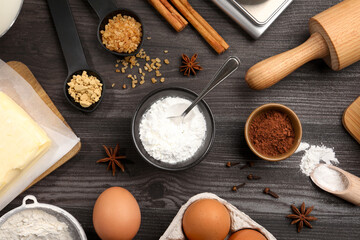 Baking powder and other products on grey wooden table, flat lay