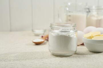 Baking powder and other ingredients for making dough on table, space for text