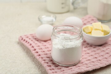 Baking powder and other ingredients for making dough on table