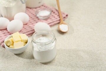 Baking powder and other ingredients for making dough on table, space for text
