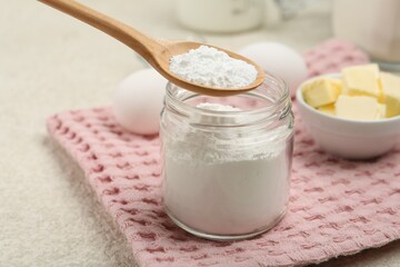 Taking baking powder with spoon at table, closeup