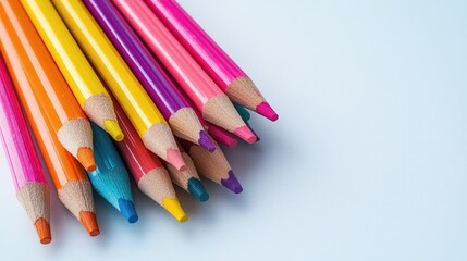 A close up shot of a bundle of colored pencils on a white background.
