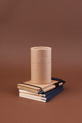 Minimalist Still Life with Books and Cardboard Tube Neutral Tones. minimalist composition featuring a stack of books in neutral colors with a cardboard tube on top, set against . High quality photo