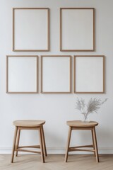 Empty Picture Frames, Wooden Stools, and Dried Flowers on a White Wall