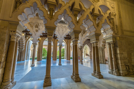 Zaragoza, Spain - July 23, 2024 : The Palacio de la Aljaferia Palace. Moorish-Taifa north side halls with multifoil arches with alabaster pillars. Fortified medieval palace, World Heritage Site.