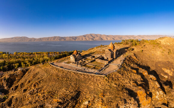 Aerial panoramic view of Surp Arakelots Holy Apostles church and chapel. Ancient Sevanavank Monastery complex and Sevan lake on sunny summer day. Travel and tourist destinations. Armenia, Europe.