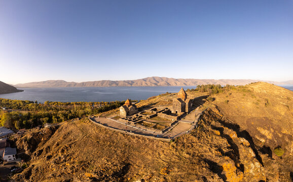 Aerial panoramic view of Surp Arakelots Holy Apostles church and chapel. Ancient Sevanavank Monastery complex and Sevan lake on sunny summer day. Travel and tourist destinations. Armenia, Europe.