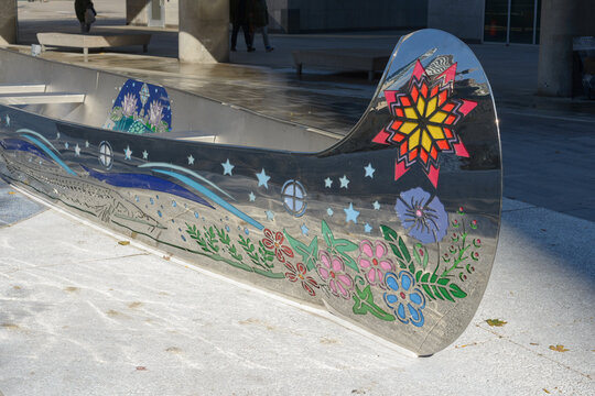 detail of Spirit Canoe a stainless steel sculpture with laser cut artwork and painted infill panels designed by Tannis Nielsen, a M&eacute;tis artist at Spirit Garden, Nathan Phillips Square, Toronto, ON