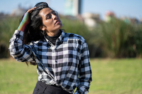 Transgender woman posing sensually in the park