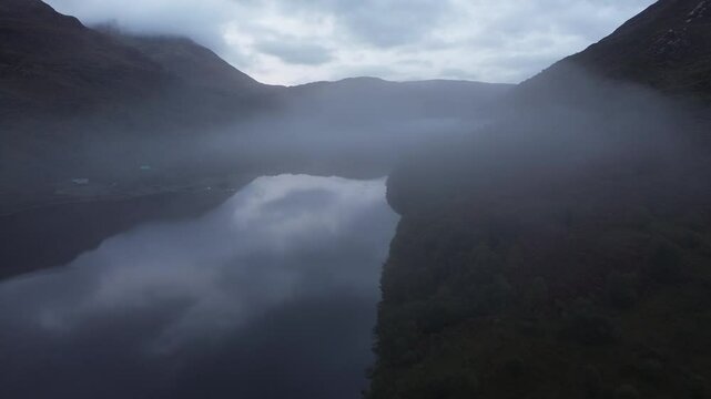 Beautiful drone clip of Loch Leven, Scotland, early in the morning, with a nice fog trapped in the valley.