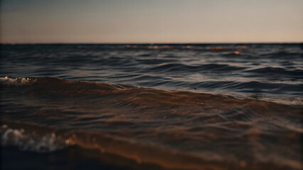 Golden hour paints the sky, casting a warm glow on the tranquil ocean waves