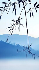   A tree branch protruding into a lake with mountains in the distance