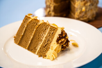 A slice of coffee and walnut cake on a plate. 