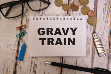 gravy train - english money idiom hand lettering on wooden blocks.