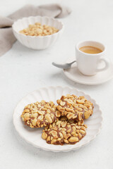 A heap of Portugues traditional peanut cookies known as Bolachas de Amendoim on the white plate