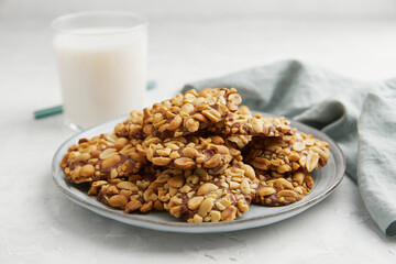 A heap of Portugues traditional peanut cookies known as Bolachas de Amendoim on the grey plate