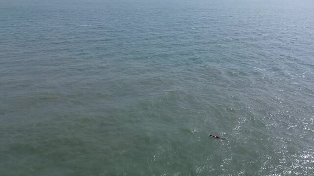 Coastal drone video of a part of Howth Head, a peninsula located northeast of the city of Dublin, Ireland, with a sea kayak.