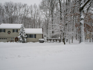 view of grey suburban house in the snowstorm